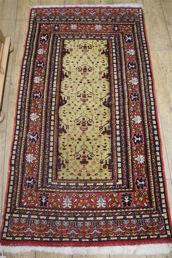 A Persian yellow field rug 170 x 90cm